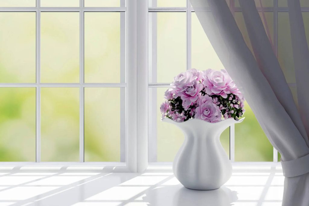 Bunch of Flowers Placed in Front of a Window